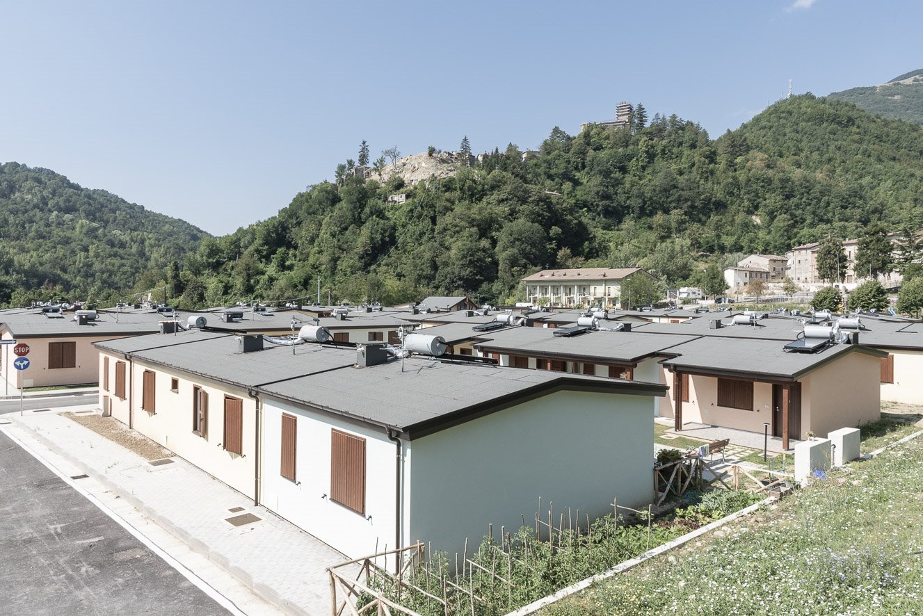 Arquata del Tronto (AP) S.A.E. Arquata Borgo 1 - data: 7 agosto 2018 - Il paese di Arquata è andato quasi completamente distrutto e forse non verrà ricostruito nello stesso sito. L’insediamento S.A.E. realizzato ai suoi piedi osserva la collina spoglia, ripulita dalle macerie dove prima sorgeva l’abitato storico di cui è rimasta solo la rocca tutelata dal Ministero dei beni e delle attività culturali e del turismo e quindi messa in sicurezza in attesa degli interventi di consolidamento. Il resto del paese storico è praticamente scomparso.